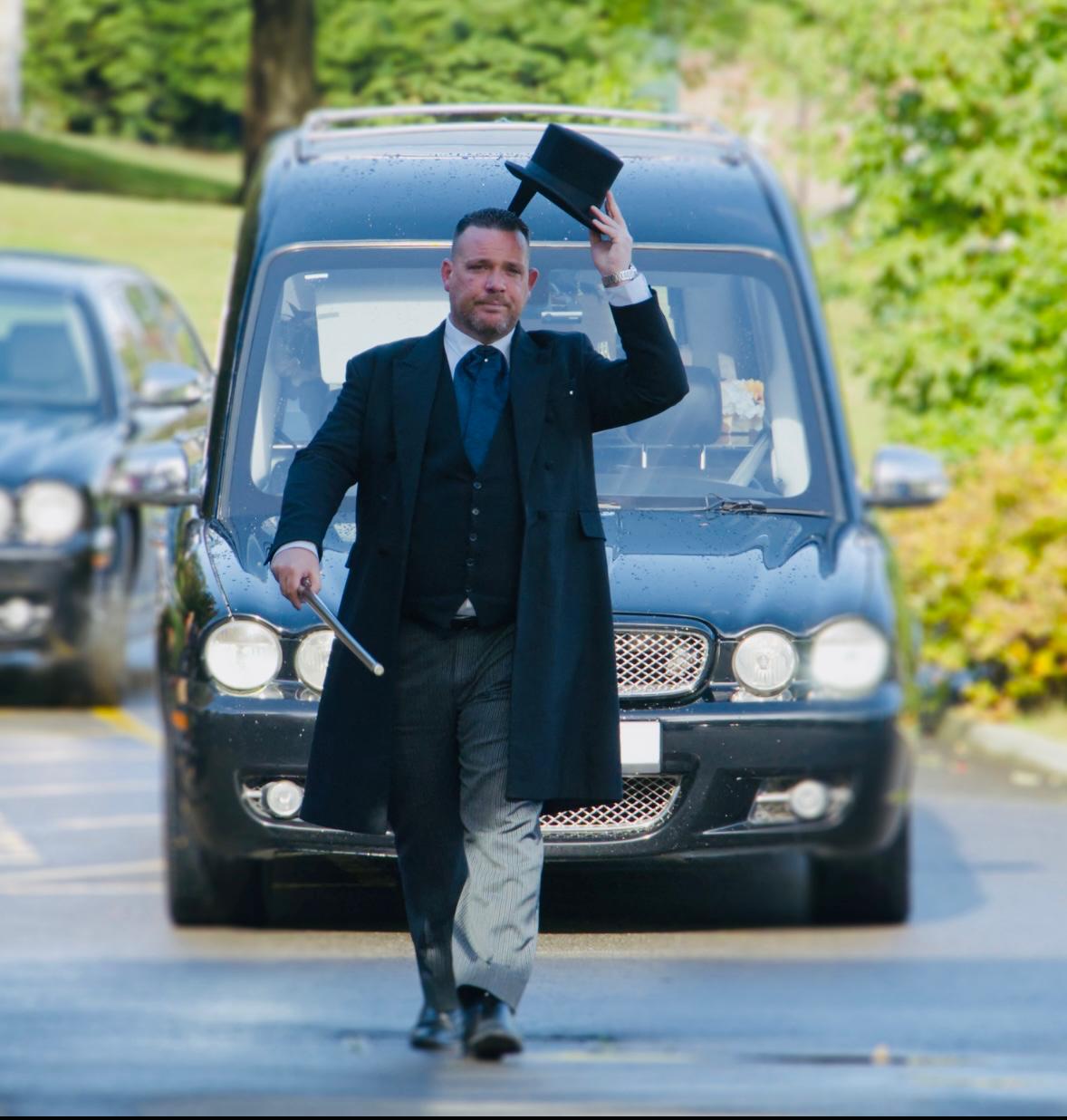 Mathew K Sutton leading a funeral procession in Sittingbourne, Kent, in front of a black hearse